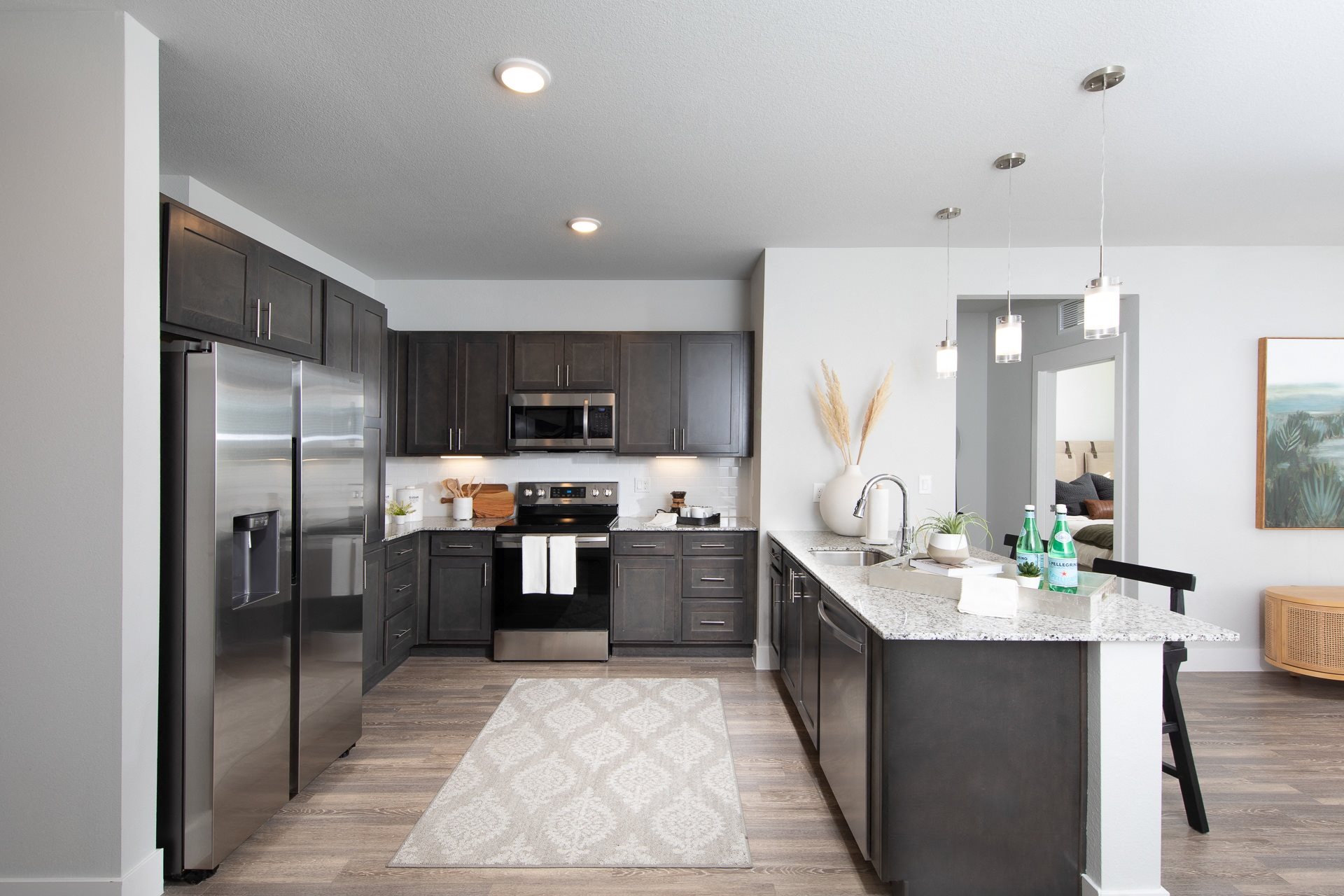 a kitchen with stainless steel appliances and a granite counter tops at a senior apartment community